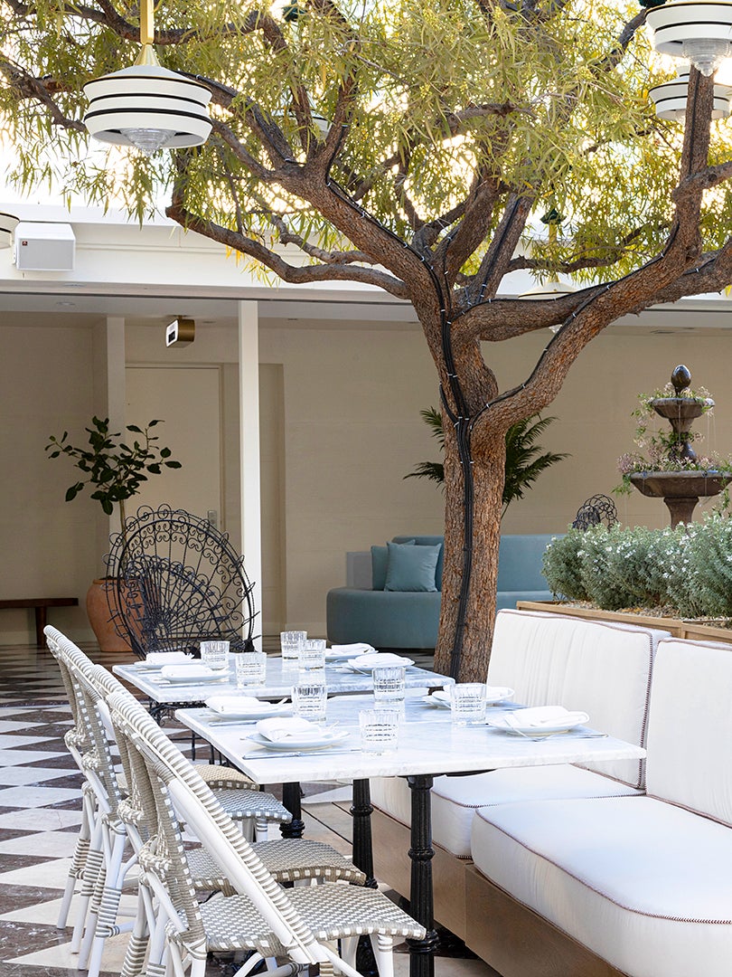 Outdoor Courtyard with Bistro Chairs and Marble Tile Floors