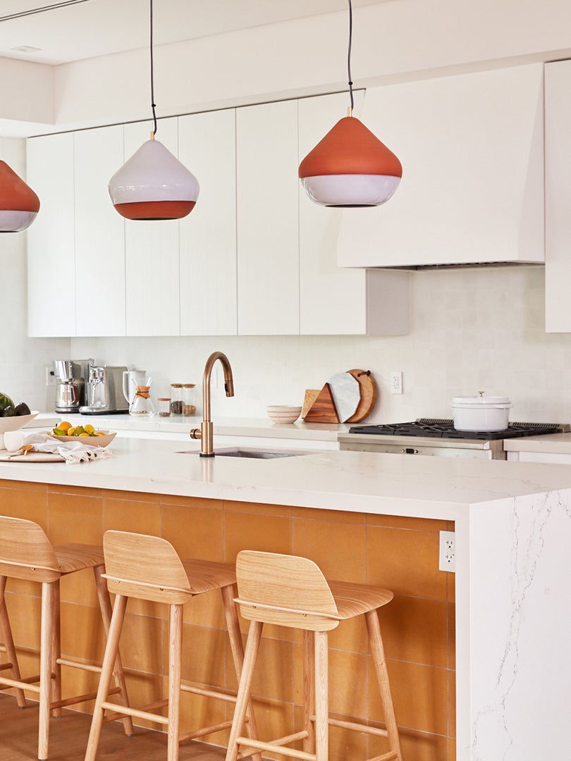white kitchen with terracotta lights