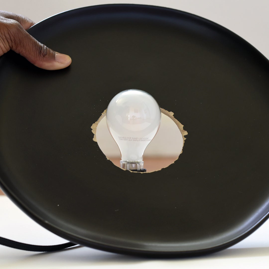 ceramic plate going over a lightbulb
