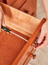 using a screwdriver to remove hardware from wooden dresser drawer