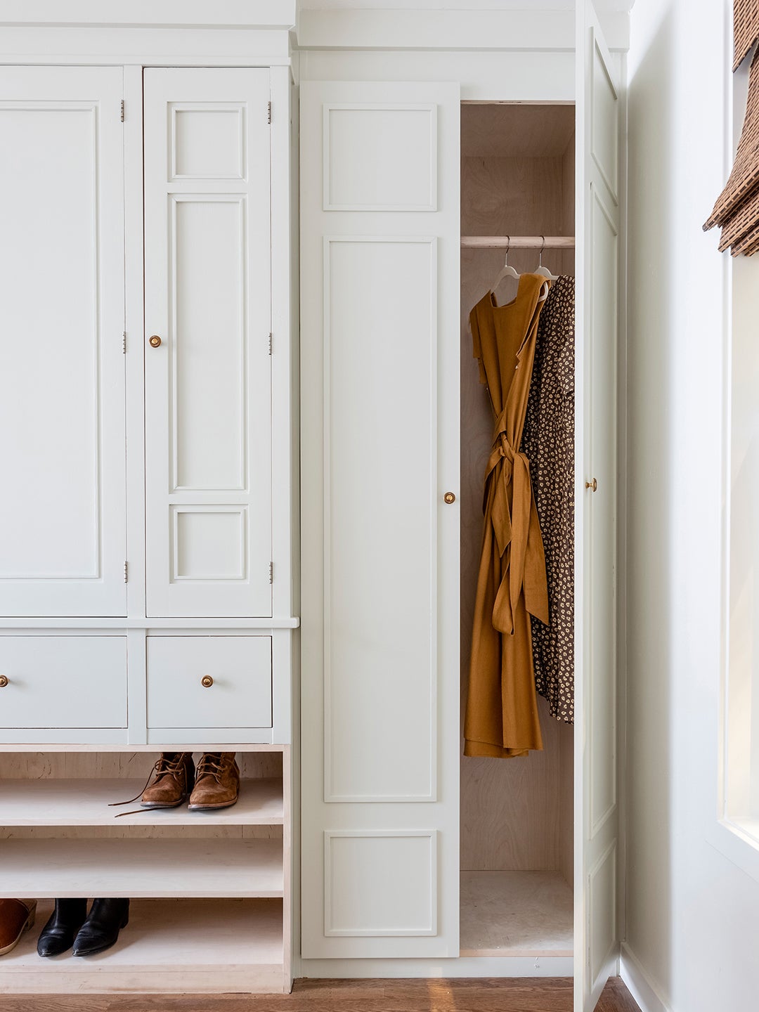 This Custom Wall of Closets Has a Storage Surprise Hidden in the Center