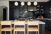 black kitchen with leather stools