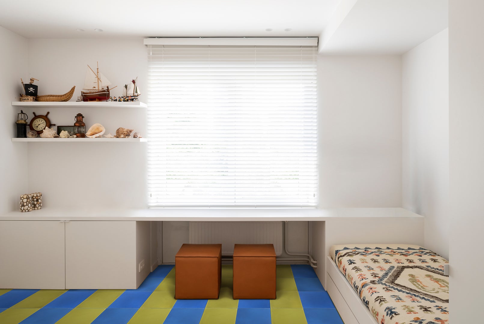 kid's bedroom with green and blue striped tile floors.
