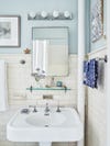 bathroom with blue walls and white pedestal sink.