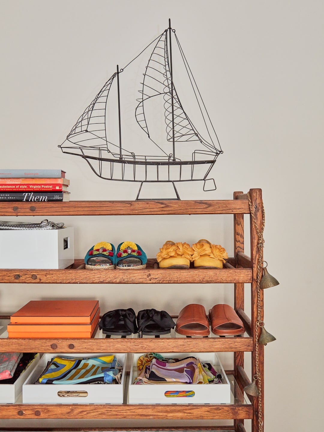 open wood shelves with iron boat model on top.
