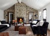 Living room with stone wall and fireplace