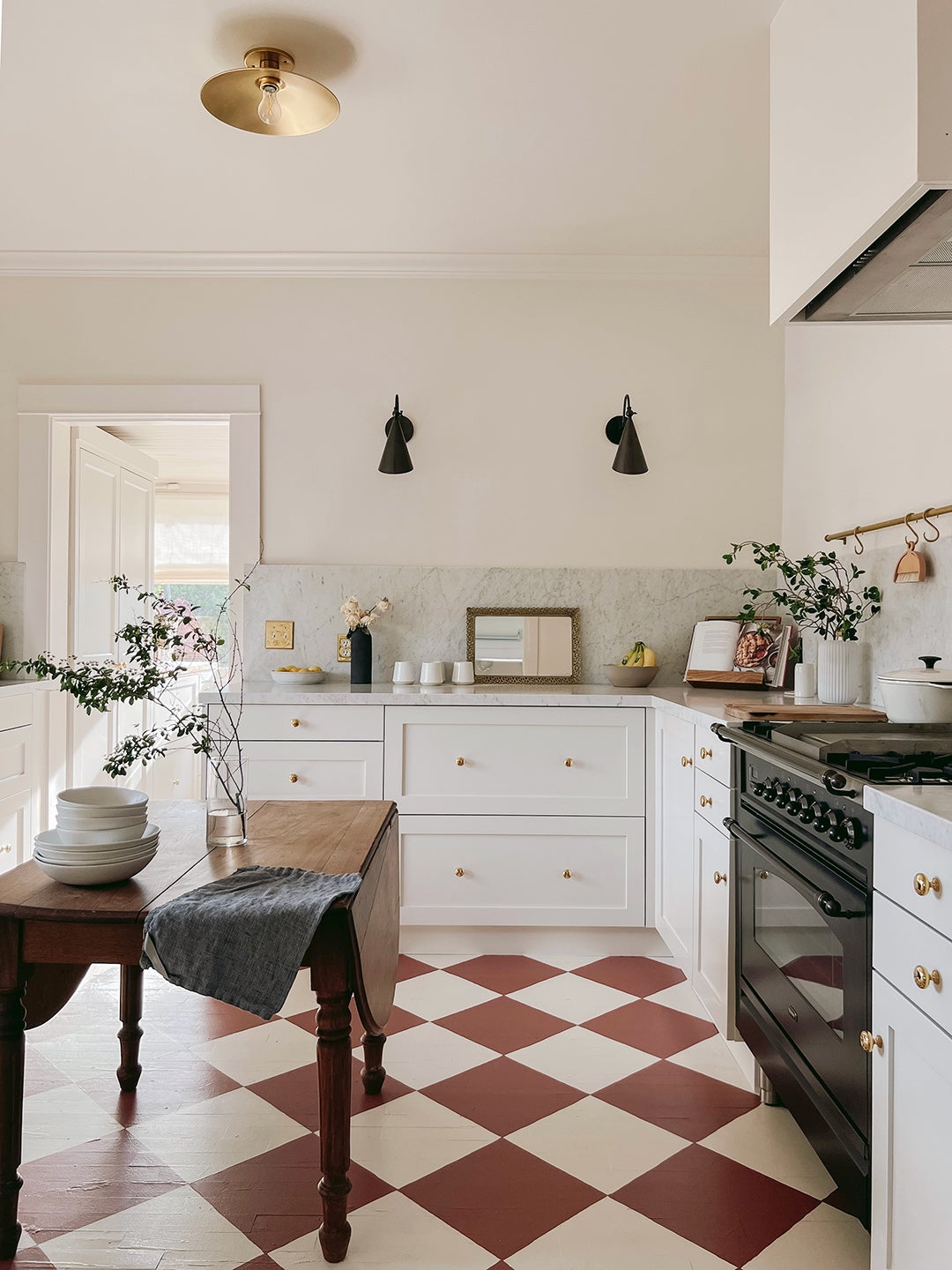 white kitchen with red checked floors