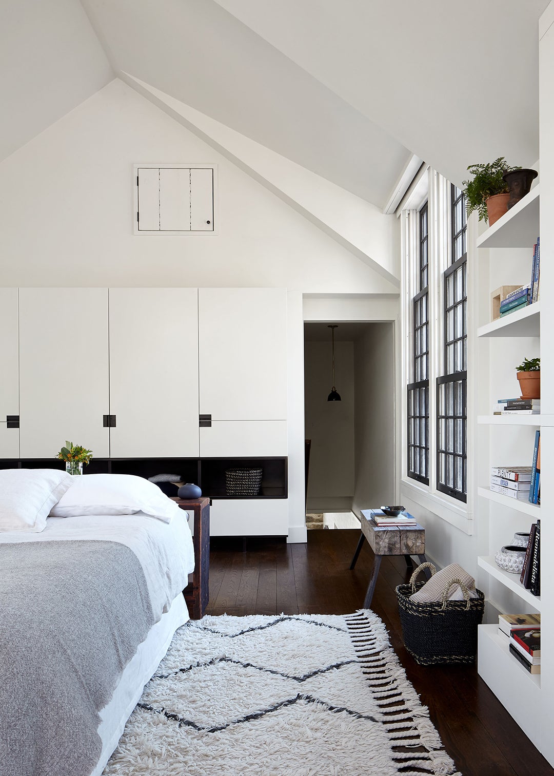 White bedroom with built in shelves