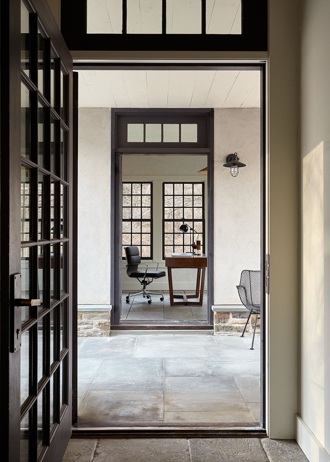 hidden office with steel frame windows and stone floors