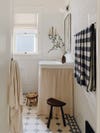 bathroom with white walls and skirted sink
