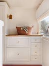 butcher block counter with woven laundry basket