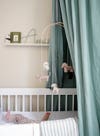 pale green fabric canopy over crib