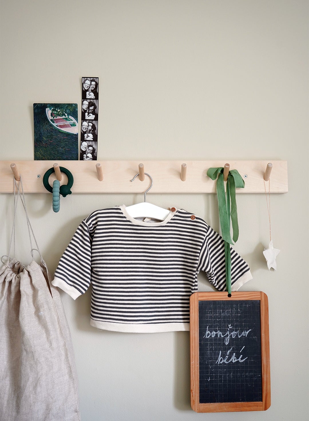 wood peg rail with kid’s shirt and mini chalkboard