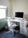 modern white desk and chair with white office accessories