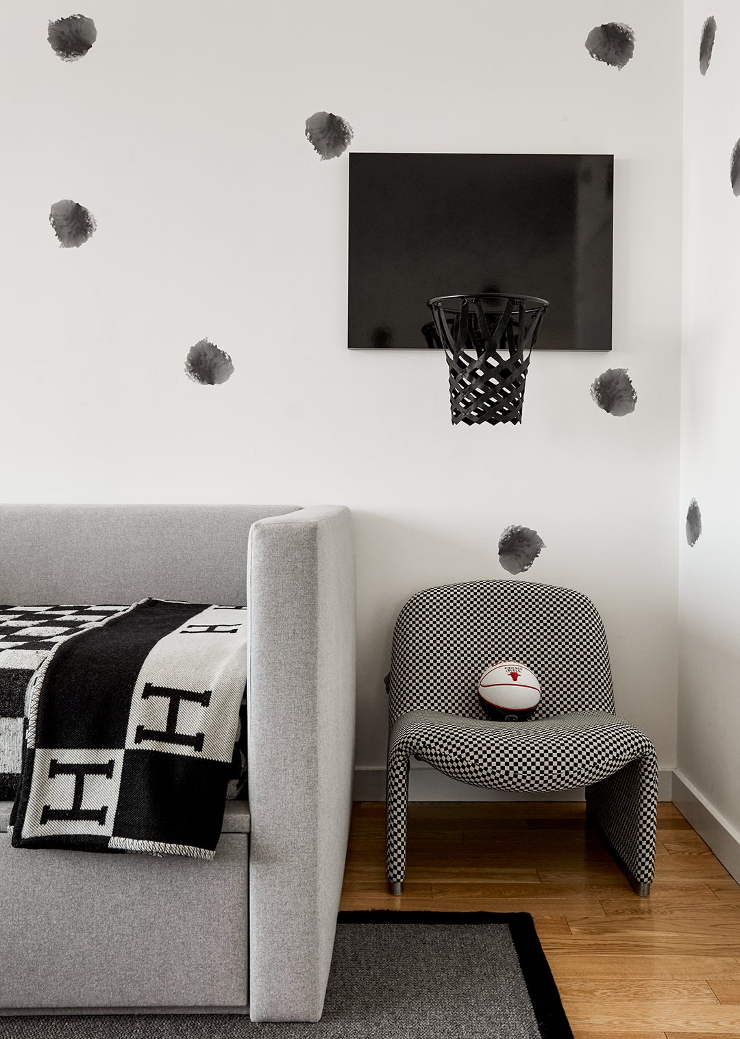 glossy black basketball hoop on black-and-white wall