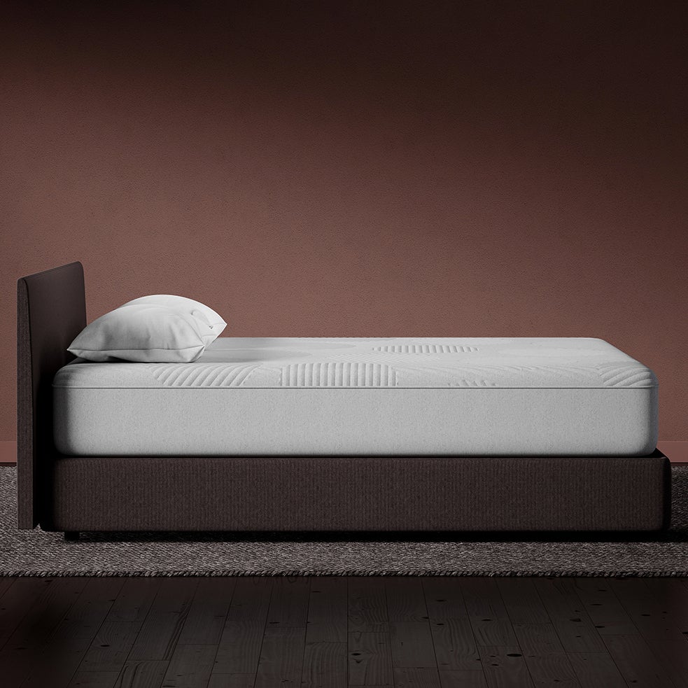 side view of casper nova hybrid mattress on wooden bed frame