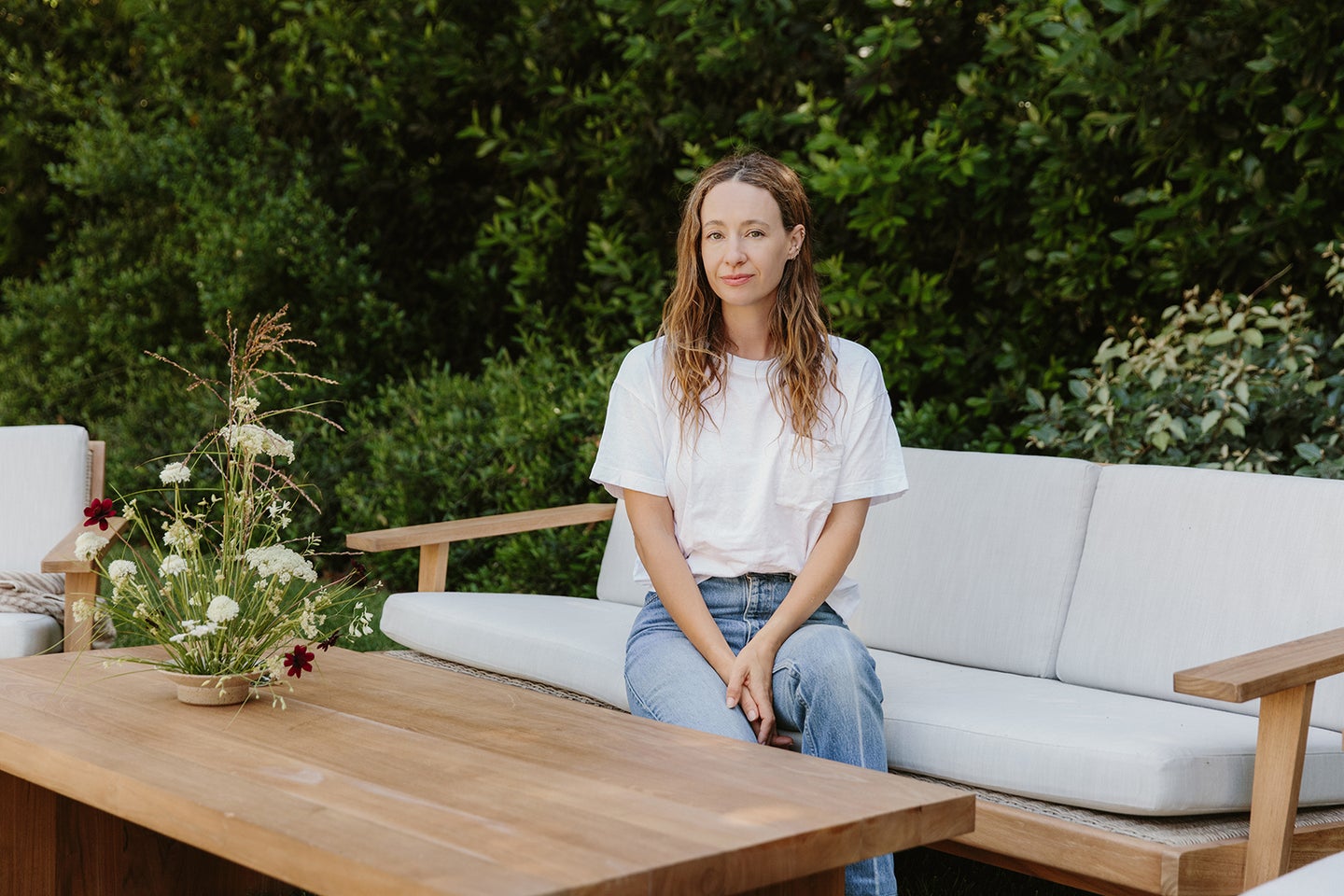 Jenni Kayne sitting on an outdoor sofa