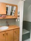 camper bathroom with green square tile