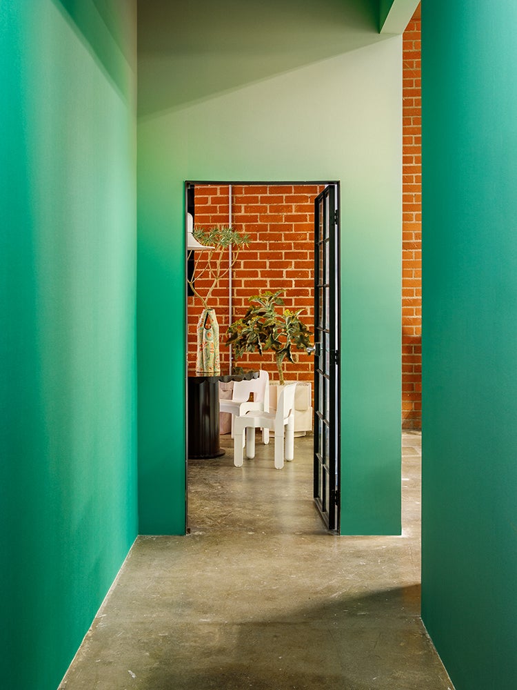 Green walls leading to office