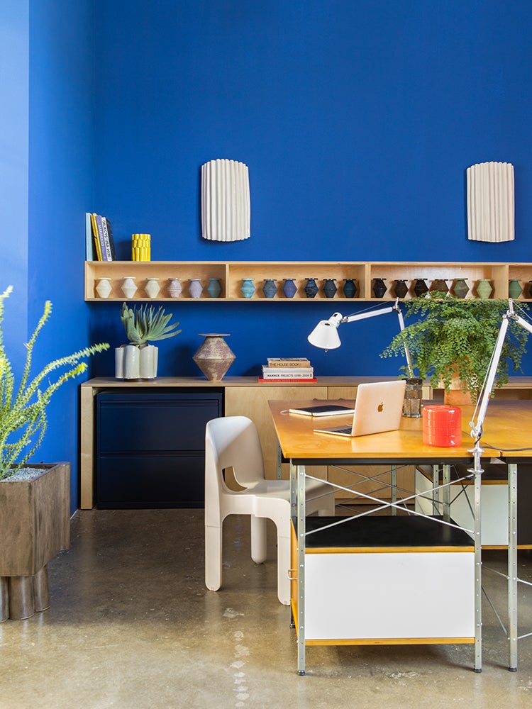Blue wall with desk and work lamp