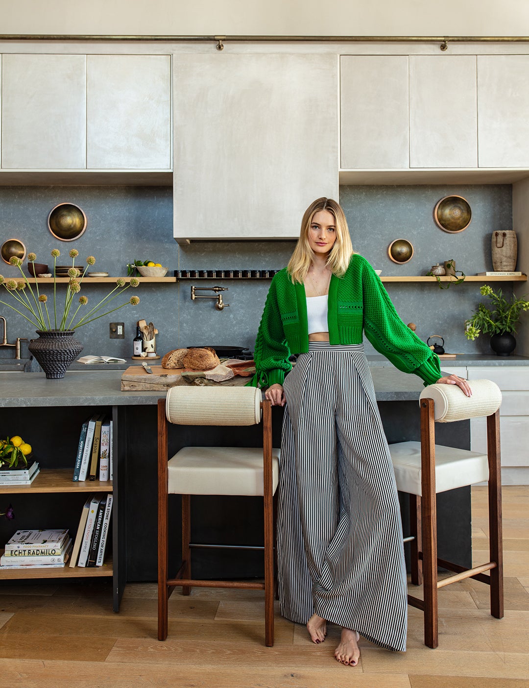 blonde model standing in a plaster kitchen