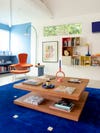 colorful sitting room with cobalt rug and wood coffee table