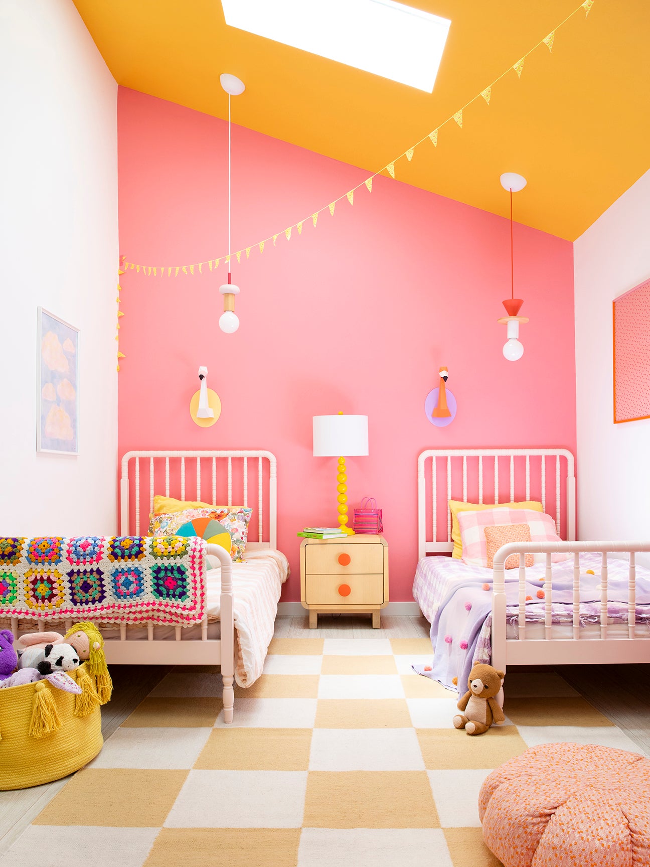 kids’ room with pink statement wall and orange ceiling