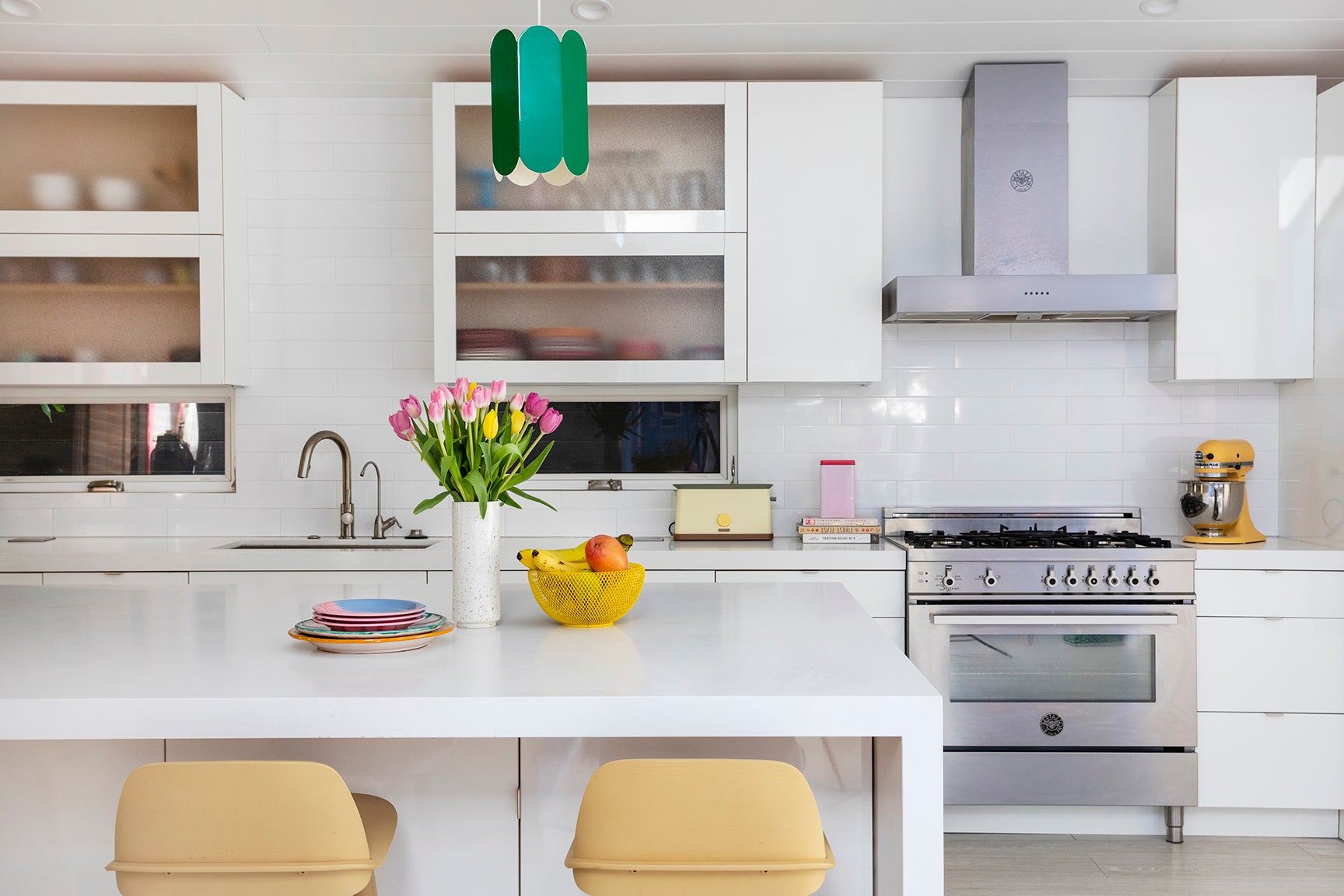 modern white kitchen with green pendant light
