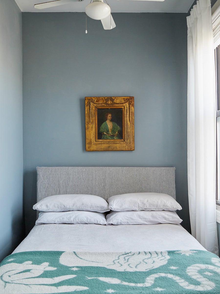 blue bedroom with striped headboard.