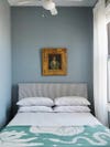 blue bedroom with striped headboard.