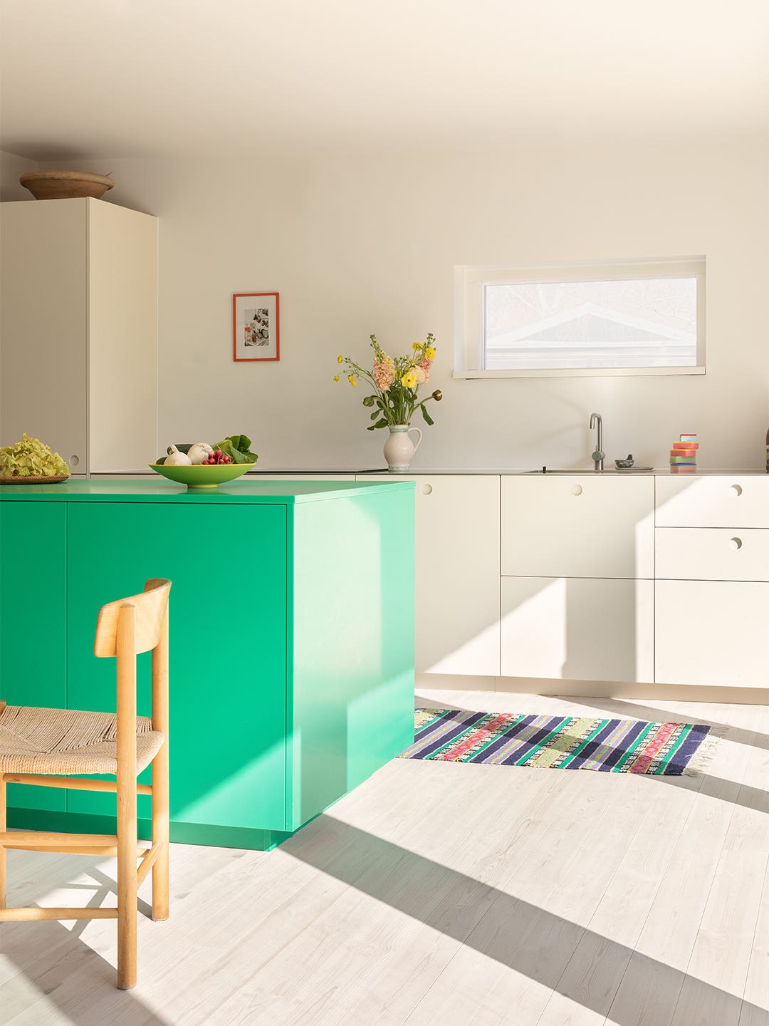 white kitchen with green island
