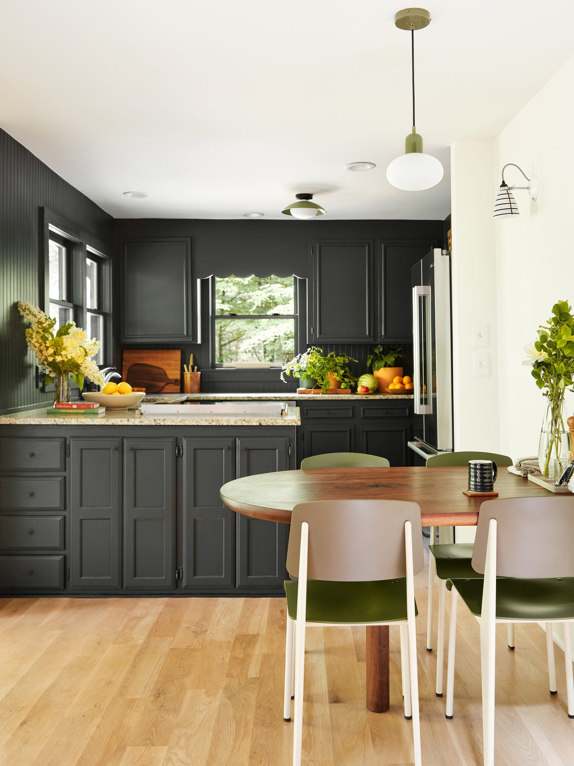 Dining nook in front of black painted kitchen 
