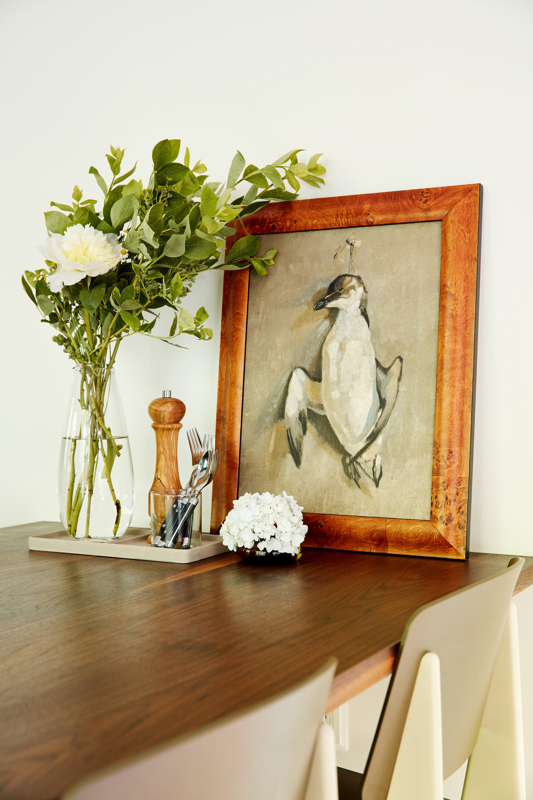 Close up shot of dining table and painting of bird
