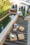 poolside patio wooden planks wicker furniture