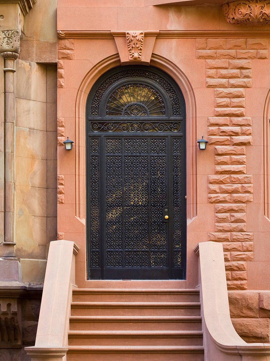 Black Iron front door framed by red brick facade.