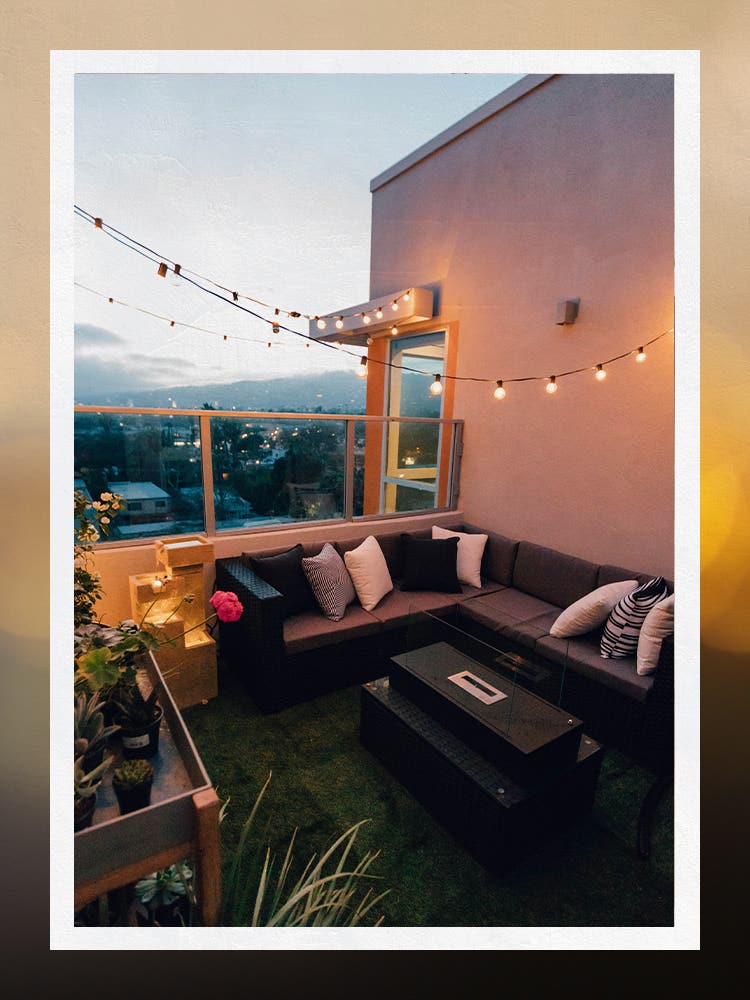 Outdoor Patio Roof with Solar String Lights Hung Above Outdoor Sofa
