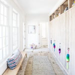 mudroom with layered beige carpets