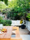 patio with wooden fence surrounded by greenery