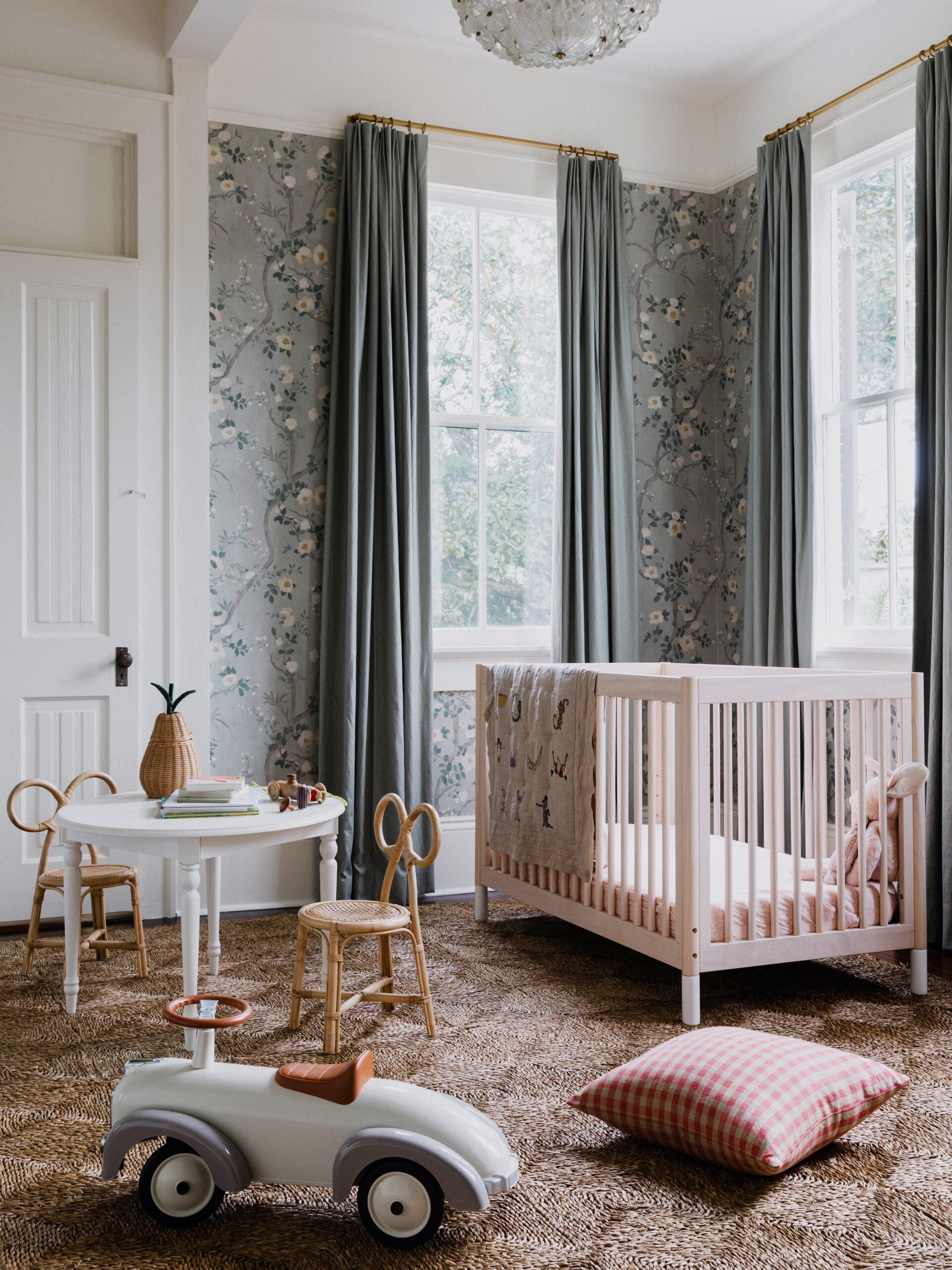 nursery with grey floral wallpaper