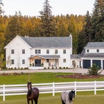 horses in front of house