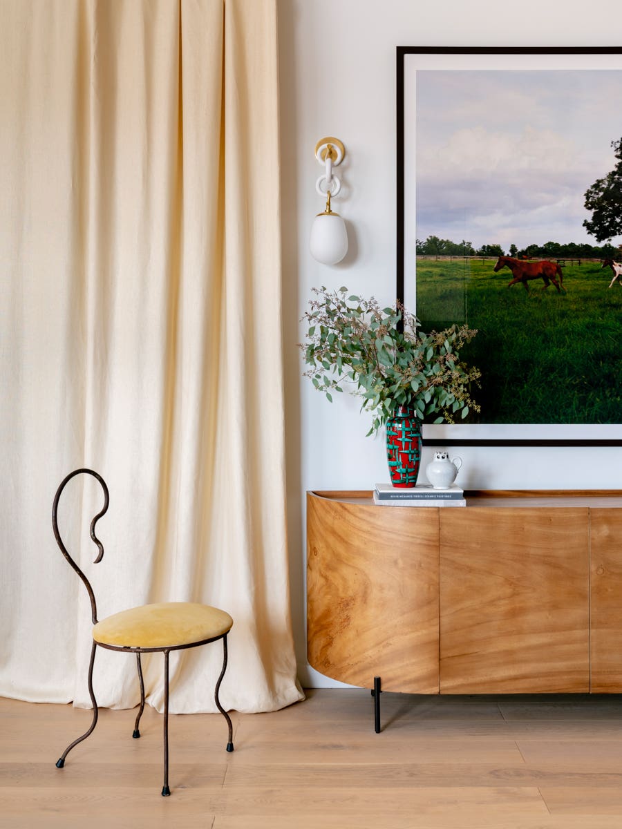 wooden credenza with hanging ceramic sconce