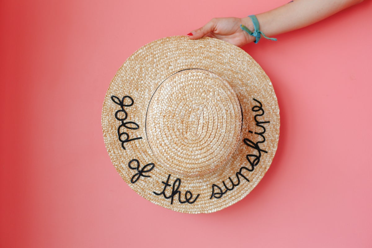 straw hat with lyrics embroidered 