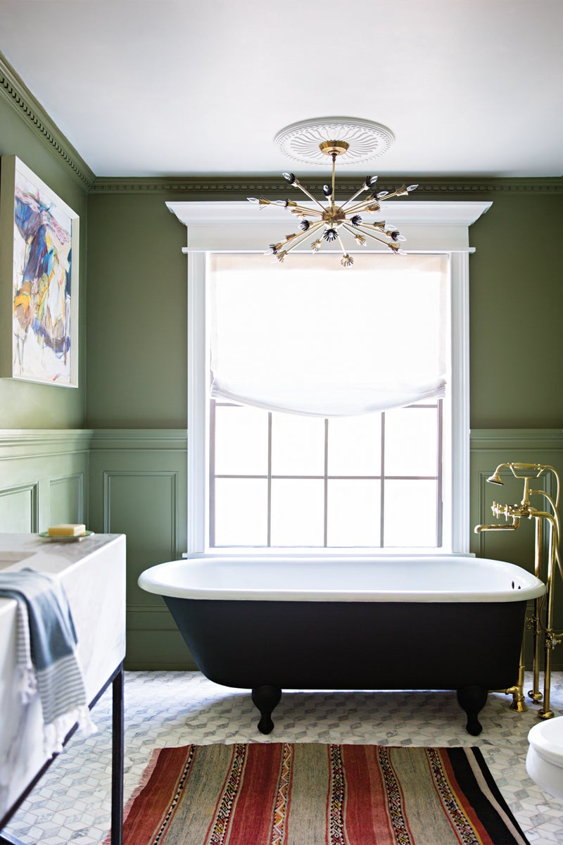 Green bathtub in brightly lit bathroom. 