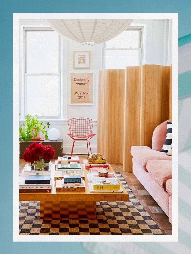 Living Room with Pink Sofa, Large Coffee Table, Checker Rug, and Bamboo Room DIvider