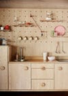 kitchen with plywood cabinets and pegboard backsplash
