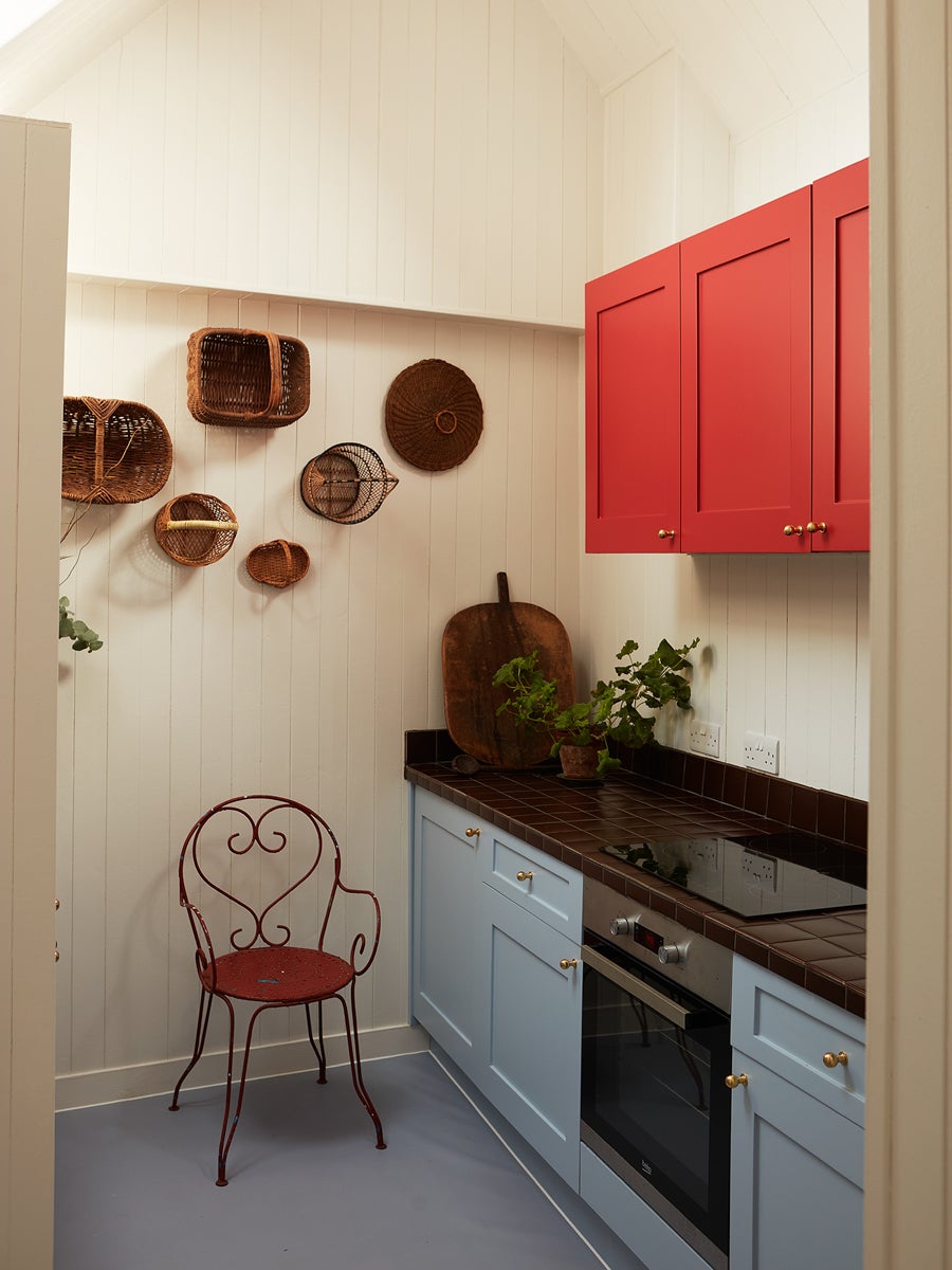 kitchen with blue lower cabinets and red upper ones