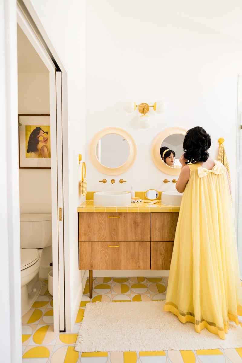 women in yellow dress in retro yellow bathroom