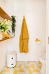 goldenrod-colored robe in yellow bathroom