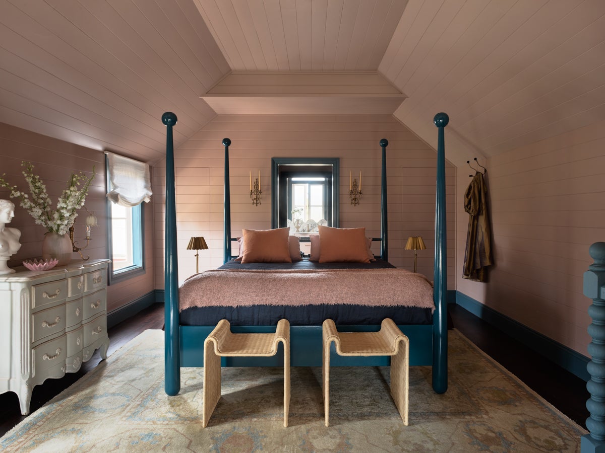 pink bedroom with teal four-poster bed frame
