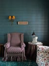checkered armchair against teal wall